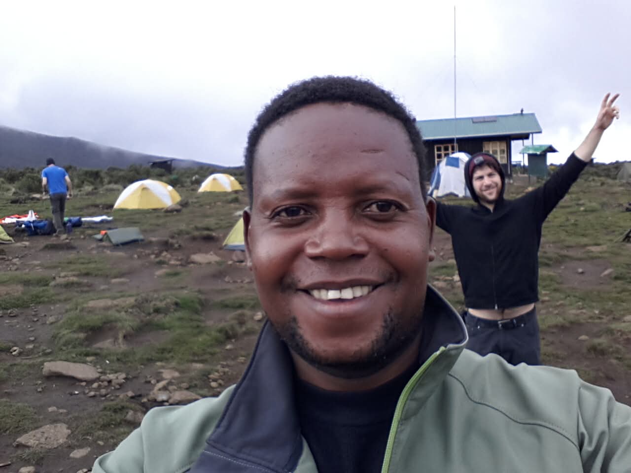 A JIPE guide smiling with a guest at camp