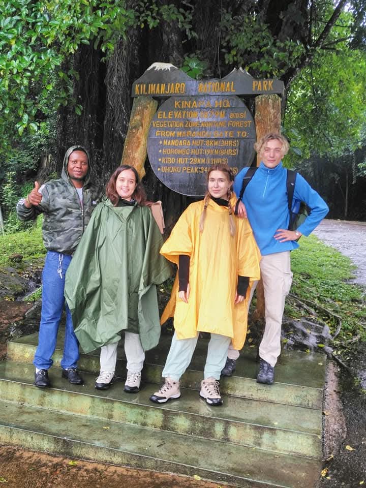Guests and guide at the Kilimanjaro National Park gate