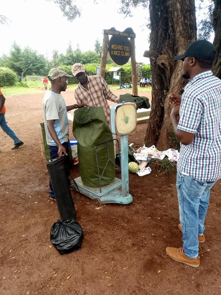Porters weighing duffel bags before the climb