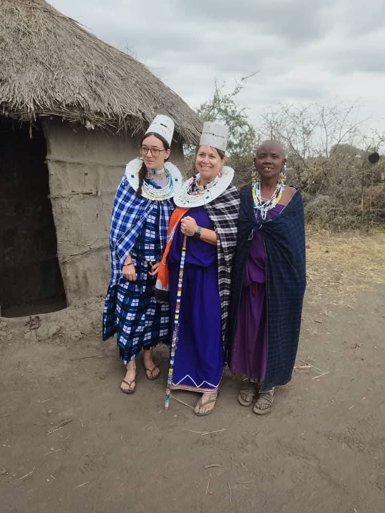 Guests dressed in Maasai attire with a local woman