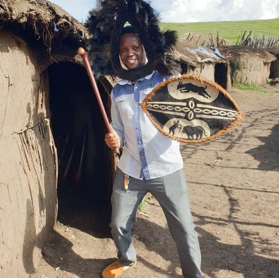 A Maasai warrior in traditional headdress with shield and club